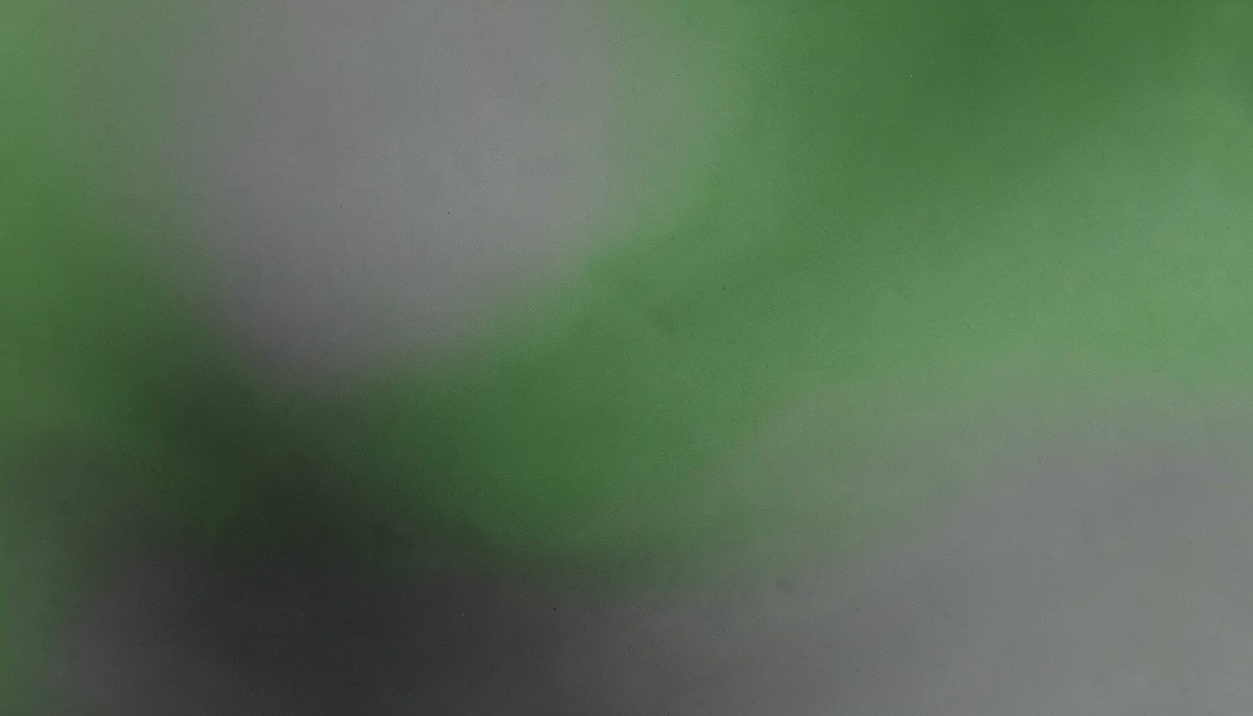 Dégradé abstrait mêlant vert sauge et gris charbon, texture lisse et apaisante